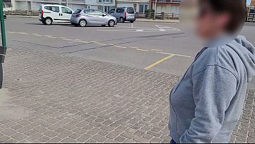 A busty milf topless on a public bench.